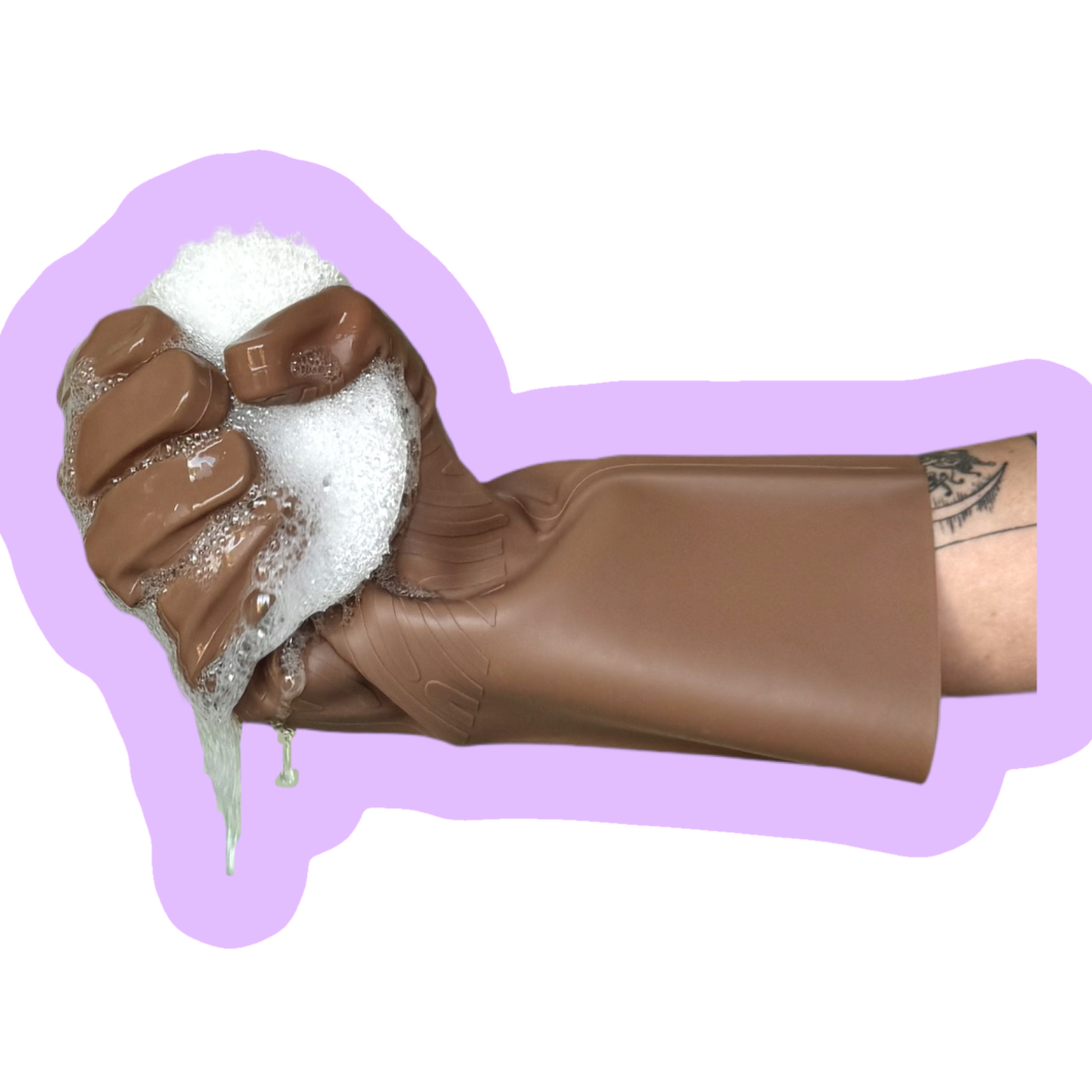 Umber keeps glove holding af white scrubbing sponge on a purple background